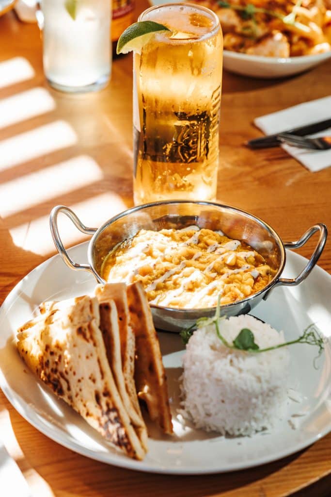 Chickpea curry with flat bread and rice and a pint of cobra lager and a wedge of lime