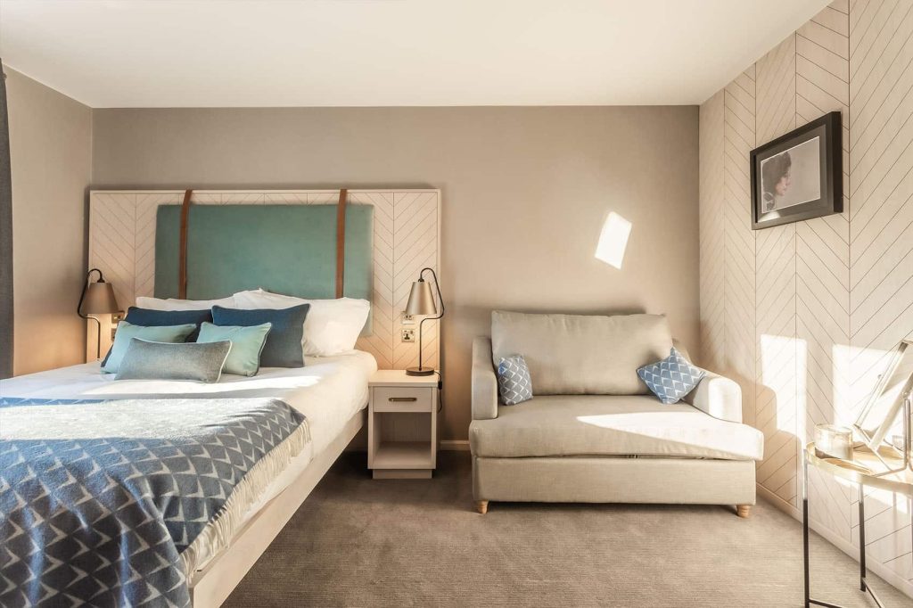 Palm Court family room with bed and sofa