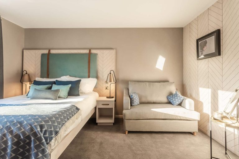 Palm Court family room with bed and sofa